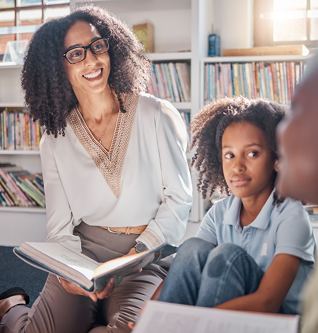 Female Teacher Reading Books with Students