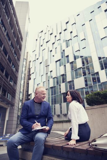 Teachers sitting outside of building