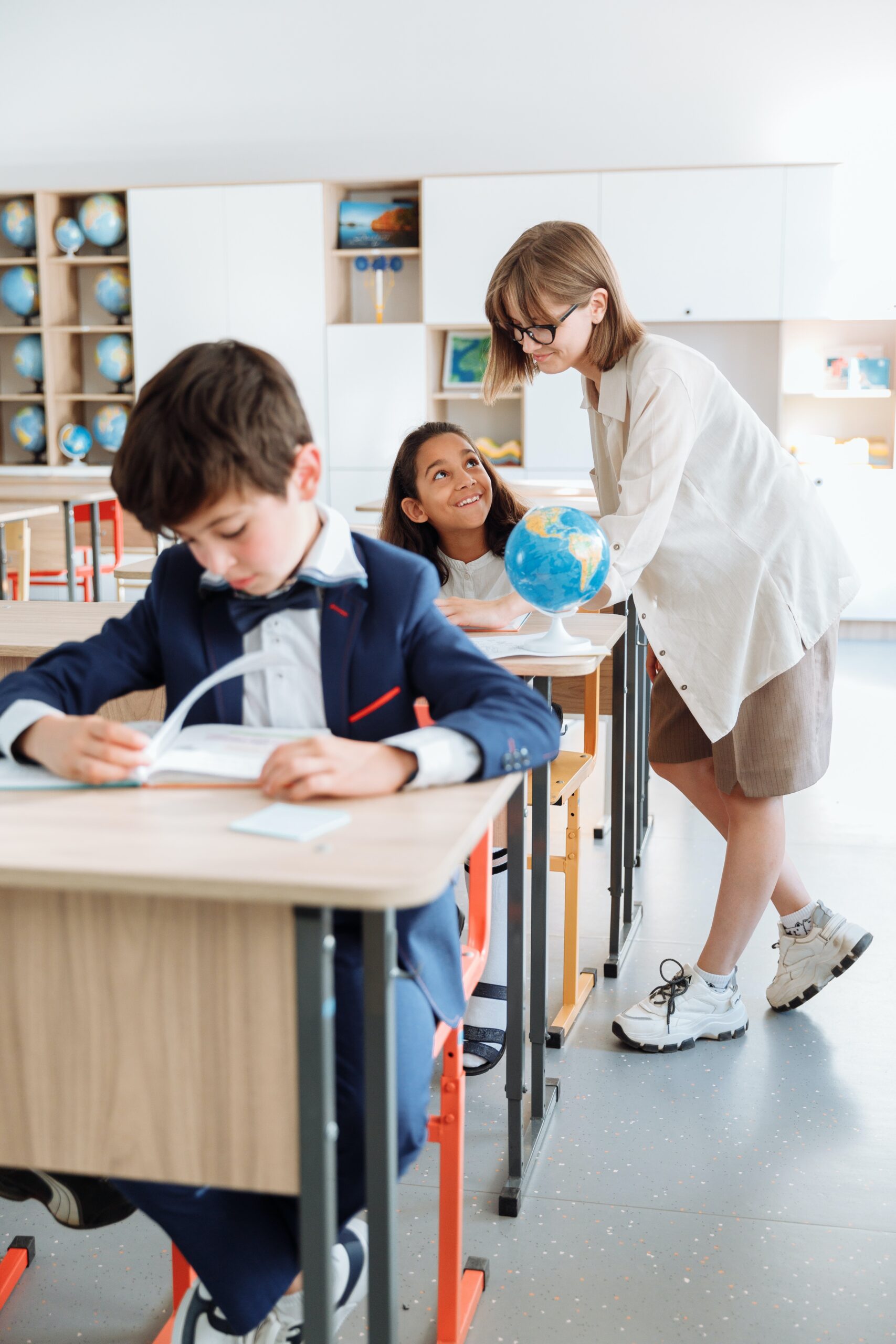 Teacher working with student at a desk