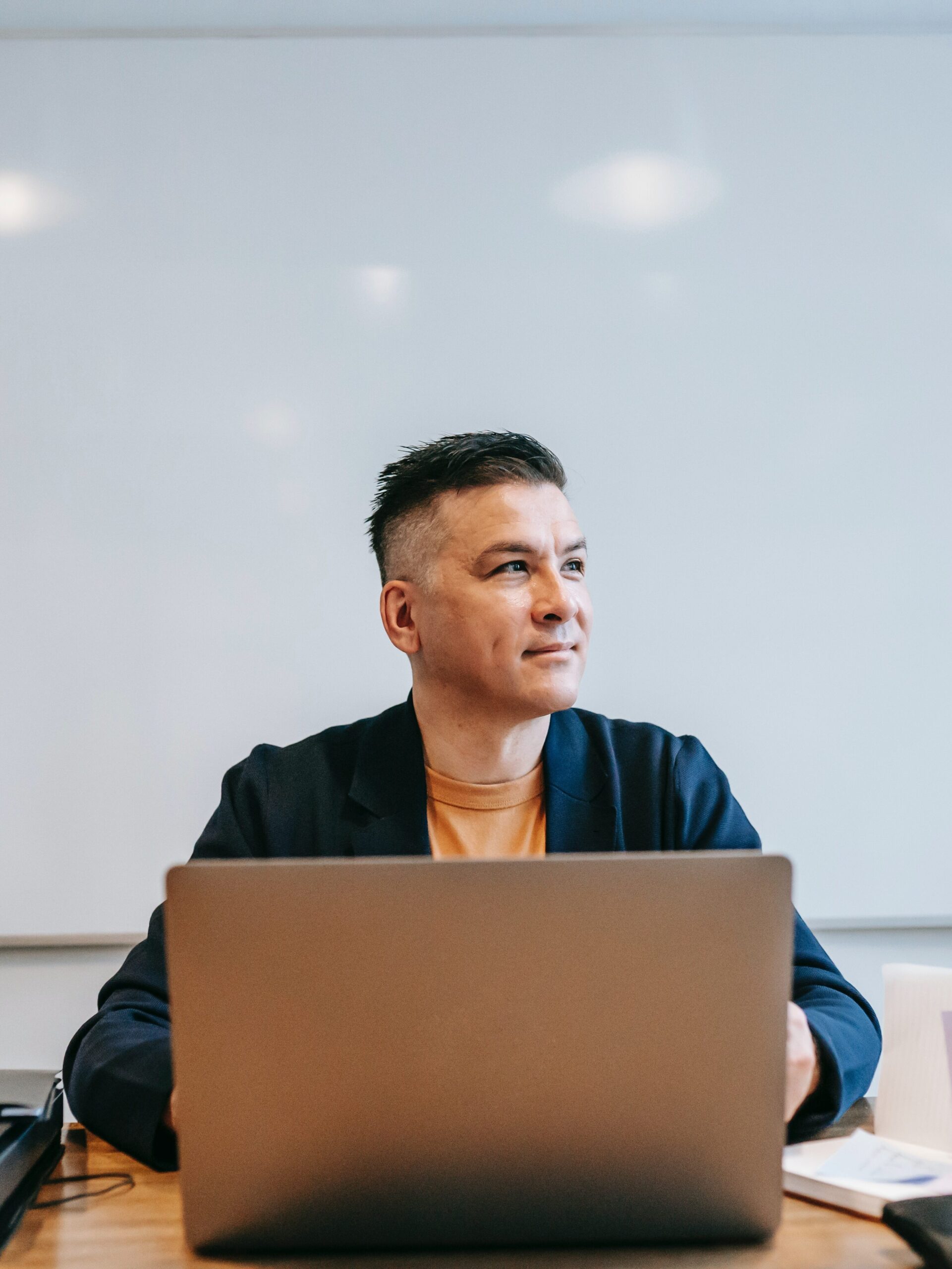 Teacher sitting at computer on desk