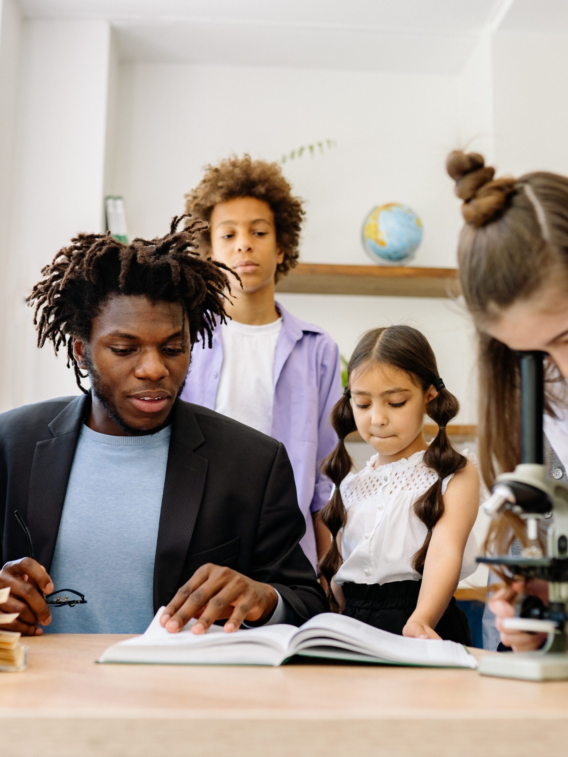 Teacher sitting with students in lecture