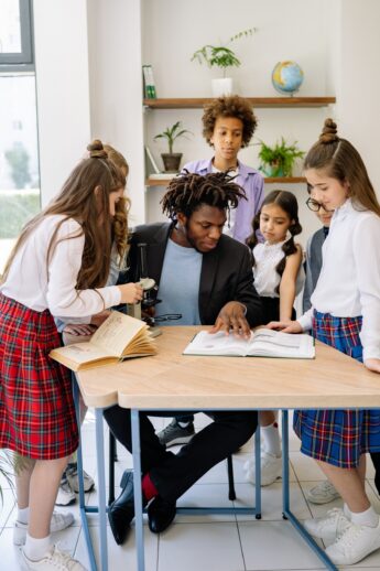 Teacher working with students at a desk